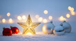 © PhotoArtHub - Image of a golden star and red, silver ornaments on snow, against lights. Represents the festive holiday season, celebration, and joyful mood
