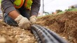 © Pringle - Fiber Optic Cable Installation: Technician Laying Cables in a Trench for High-Speed Internet