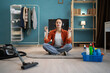 © Andrii Lysenko - Young housewife meditating on floor taking break from house chores. house cleaning concept