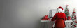 © Edgar Martirosyan - back view of santa claus sitting at the computer