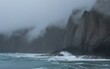 © MstRuzina - Dramatic cliffs meet the stormy sea in a misty landscape