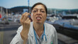 © Krakenimages.com - Woman doctor in white coat with stethoscope points finger on street with grimacing face; insistence frustration.