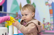 © splitov27 - Little cute baby plays in a children's entertainment center