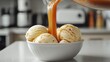 © VALENTYNA - Thick caramel sauce drip cascading stream vanilla ice cream scoops white bowl modern kitchen counter food styling