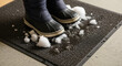 © Iryna - Melting snow on shoes in office lobby, winter footwear and wet floor safety