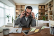 © Migma_Agency - Man feeling stressed during phone call while working remotely