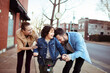 © Davor - Adult mother and father help joyful child ride bike on city sidewalk