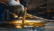 © 19.911a Digital - Gloved hand operating a brass torch over a wet, reflective industrial surface with splashes.