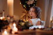 © Halfpoint - Little girl is praying during Christmas dinner.