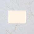© creativestore - Blank cream colored rectangular card on a marble background