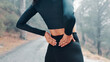 © peopleimages.com - Outdoor, back pain and woman with fitness, tension and accident with burnout or training. Female person, nature and runner with exercise, joint injury or frustrated athlete with muscle strain