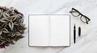 © MindRender - Top view of an open blank notebook with a pen, eyeglasses, and a potted plant on an elegant white marble desk