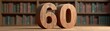 © Roman - Number 60 on a table in front of a bookcase