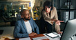 © Wess/peopleimages.com - Business, people and explain with computer at night for training, finance report and budget. Staff, pc and coaching for audit procedure, financial evaluation and working late for investment deadline
