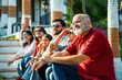 © StockImageFactory - Indian family enjoying outdoor bonding time on steps during weekend relaxation