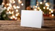 © Johannes - blank christmas card mockup on wooden table with festive bokeh lights in the background ideal for holiday greetings or invitations with copy space for customization