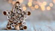© Puckung - eco friendly Christmas Decorative star made from rolled paper tubes with blurred lights in background.