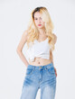 © Bangkok Click Studio - Asian confident beautiful attractive young woman blonde long hair stand wear sleeveless top jeans on white background studio, portrait lifestyle fashion street outfit trendy style pose look at camera.
