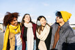 © Xavier Lorenzo - Diverse young group of friends laughing together outdoor during winter season. Friendship and youth concept