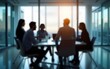 © wang - Group of professionals engaged in brainstorming session inside glass-partitioned boardroom - business meeting concept with blurred effect. High quality. High quality