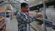 © tol_u4f - Shopping for ceramic planters in a gardening center during a sunny afternoon with various plant pots neatly organized on shelves