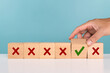 © sichon - A Man selects checkbox with green checkmark from row of multiple boxes with red crosses. Strategy of choice, positive or negative, decision, accept and decline