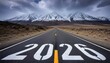 © Husen - Road to 2026: A highway stretches towards snow-capped mountains under a dramatic sky.