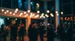 © Maryam - Blurry gathering of people under warm ambient lights at an evening corporate event or party in a