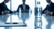 © Maryam - Business meeting with water bottle, notepad and pen on a glossy conference table