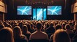 © Amal - Engaged audience attentively watching a speaker present on a large stage adorned with vibrant