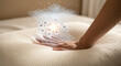 © Kudrat - Closeup of a hand pressing into a soft pillow, with animated particles and bubbles representing comfort, support, and advanced material technology