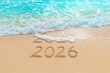© RAZI - Message Year 2025 replaced by 2026 written on beach sand background. Good bye 2025 hello to 2026 happy New Year coming concept.