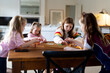 © Austockphoto - Young girls playing colourful rectangular blocks on the table