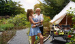 © romaset - A couple of man and woman in front of a tent at glamping.