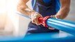 © sungedi - Skilled worker uses specialized tool to cut a large diameter blue plastic pipe in a brightly lit workspace