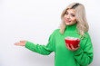 © luismolinero - Young Russian woman holding a bowl of cereals isolated on white background extending hands to the side for inviting to come