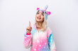 © luismolinero - Young Russian woman with unicorn pajamas isolated on white background pointing up and surprised