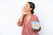 © luismolinero - Young hispanic woman holding eggs isolated on white background shouting with mouth wide open to the side