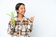 © luismolinero - Young hispanic woman holding a green beans isolated on white background intending to realizes the solution while lifting a finger up