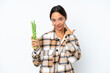 © luismolinero - Young hispanic woman holding a green beans isolated on white background giving a thumbs up gesture