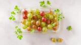 Fresh isolated gooseberries on white background top view. Generative AI