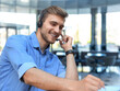© ty - Smiling friendly handsome young male call centre operator