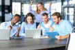 © ty - Happy business people laugh near laptop in the office. Successful team coworkers joke and have fun together at work.