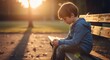 © Margarita Ratatosk - Little boy child sitting alone on a park bench looking down in sadness, demonstrating feelings of autism spectrum disorder, developmental delay