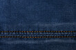 © Akova - Denim fabric with yellow thread seams, denim jacket, denim pants, for background or fabric sample sale.