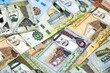 © mehaniq41 - Saudi Arabia riyal money bills banknotes lies in big pile on table close up. Concept of finances and business in Saudi Arabia