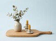© mohdfaizal - Candles and vase with eucalyptus on wooden board