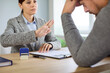 © Studio Romantic - Job interview rejection during business documents and employees resume review on meeting in office. Female recruiter showing denial gesture to male candidate sitting at desk with stress and despair