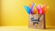 © Pete - Brown paper bag shows thank you message filled with bright colorful tissue paper. This gift presentation conveys gratitude and appreciation. Its cheerful style suits any special occasion or event.