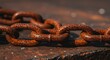 © chaiwat - Close up view of heavy metal links showing deep orange and brown corrosion, lying on a rough industrial surface, symbolizing neglect and age ,surface ,oxidation ,anchor